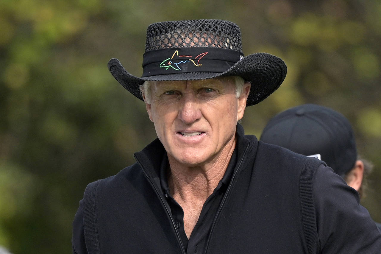 FILE - Greg Norman walks on the first hole after hitting his tee shot during the final round of the...