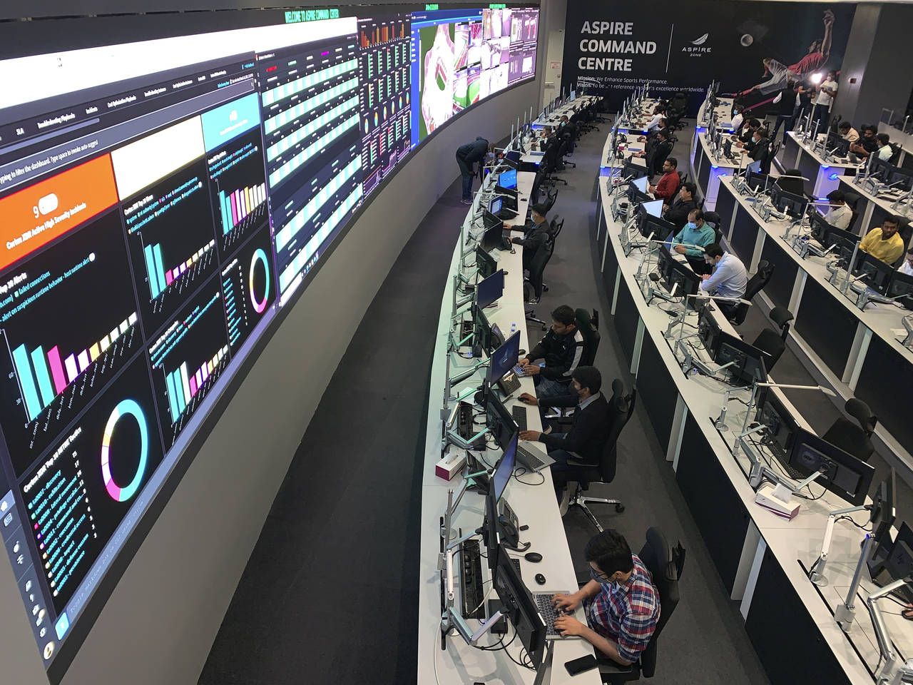 People work in the command center in that will be at the heart of World Cup operations in Doha, Qat...