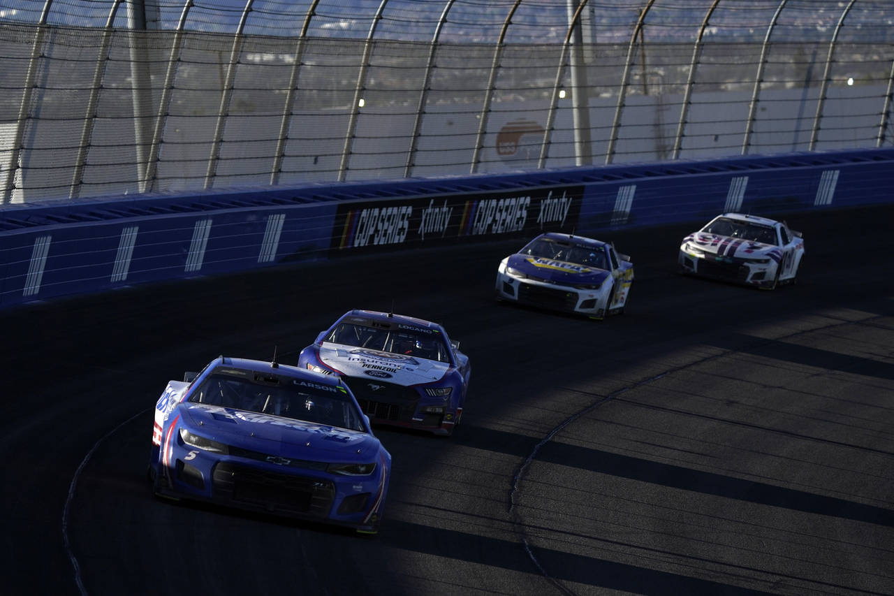 From left, Kyle Larson races ahead of Joey Logano, Chase Elliott and Alex Bowman during the NASCAR ...