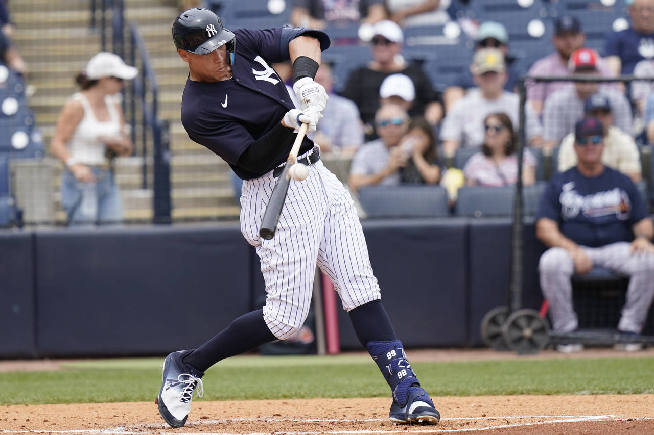 New York Yankees' Aaron Judge hits a solo home run during the first inning of a spring training bas...
