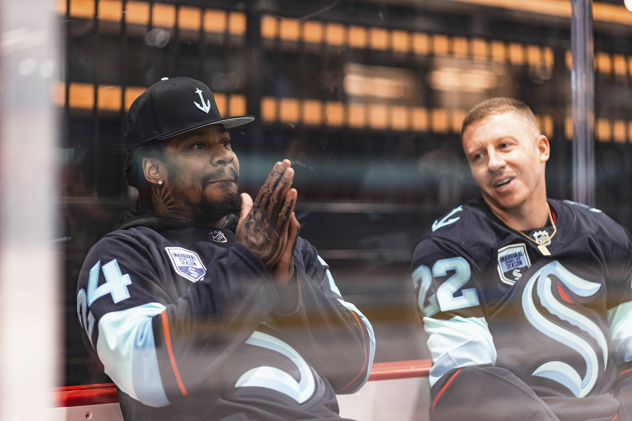 In this photo provided by the Seattle Kraken NHL hockey team, former Seattle Seahawks NFL football ...