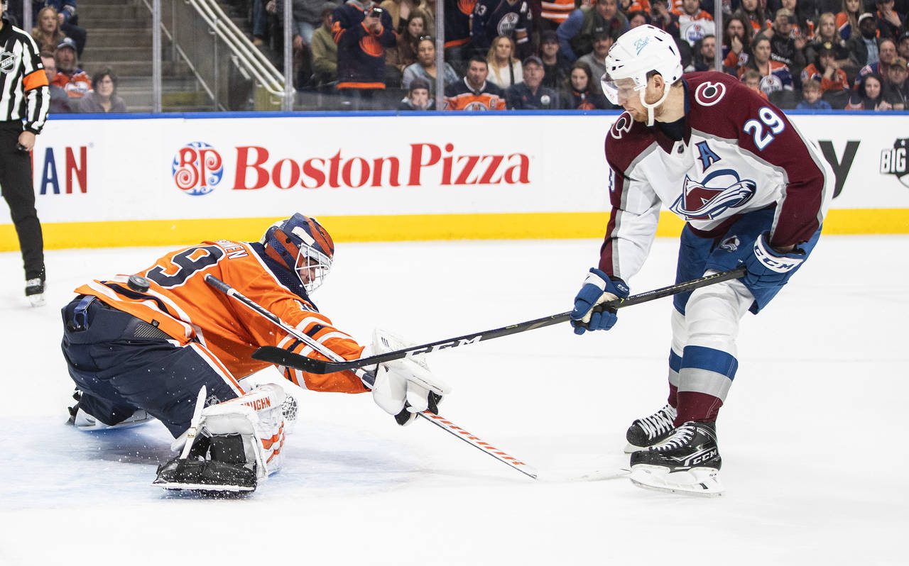 Colorado Avalanche' Nathan MacKinnon (29) scores on Edmonton Oilers goalie Mikko Koskinen (19) duri...