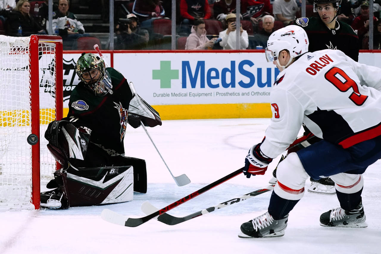 Washington Capitals defenseman Dmitry Orlov (9) shoots wide of Arizona Coyotes goaltender Karel Vej...