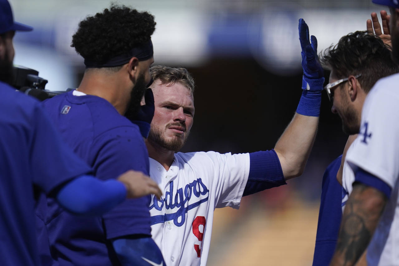 Los Angeles Dodgers' Gavin Lux (9) celebrates with teammates after hitting a walk-off double to win...