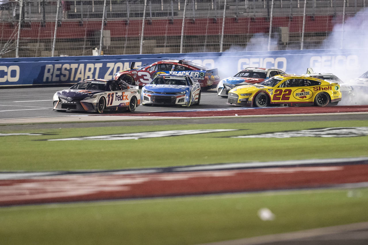 Joey Logano (22), Kyle Larson (5) and Austin Dillon (3) wreck behind Denny Hamlin (11) during a NAS...