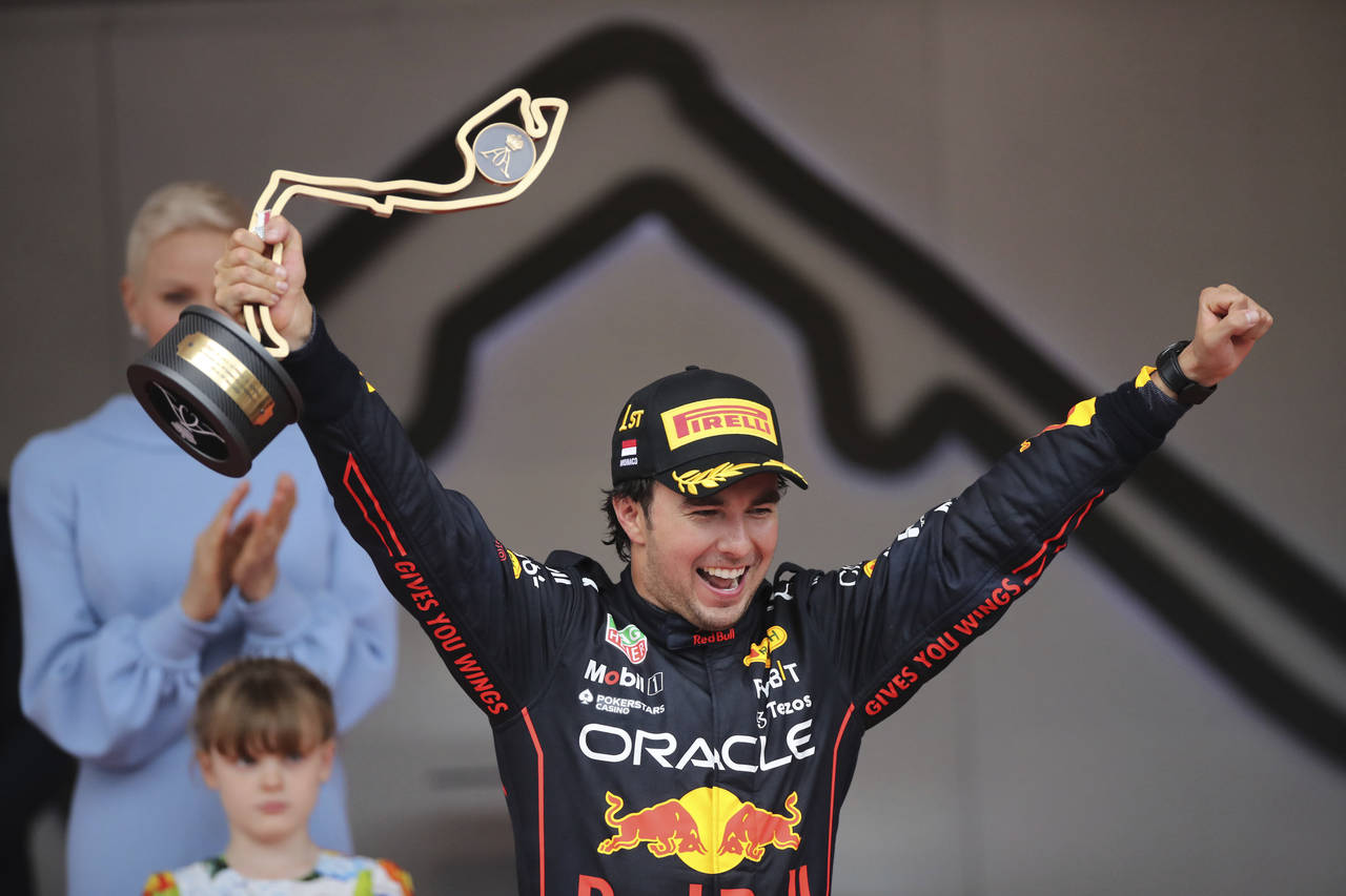 Red Bull driver Sergio Perez of Mexico celebrates on the podium after winning the Monaco Formula On...