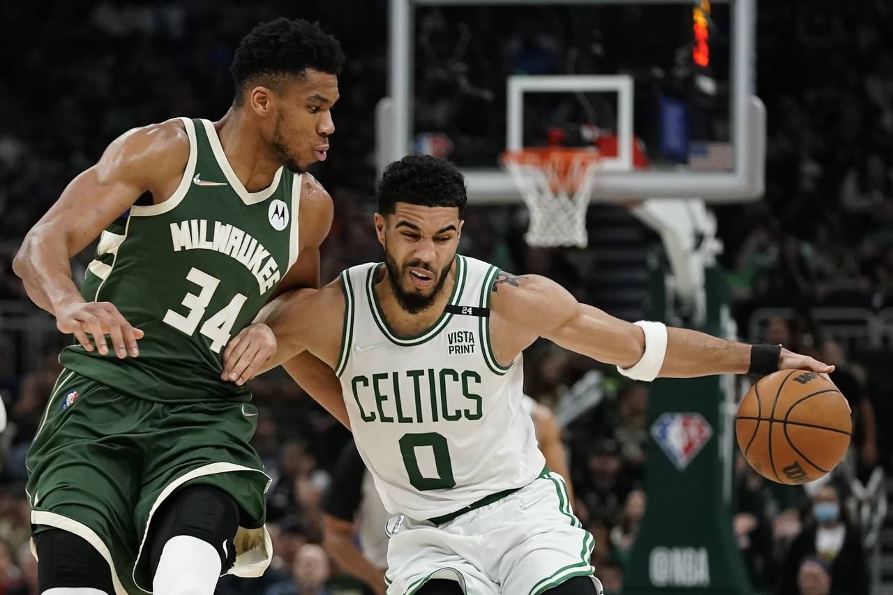 Boston Celtics' Jayson Tatum tries to get past Milwaukee Bucks' Giannis Antetokounmpo during the se...