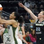 
              Seattle Storm forward Gabby Williams, left, shoots in front of Chicago Sky guard Courtney Vandersloot (22) during the first half of a WNBA basketball game Wednesday, May 18, 2022 in Seattle. (AP Photo/Ted S. Warren)
            