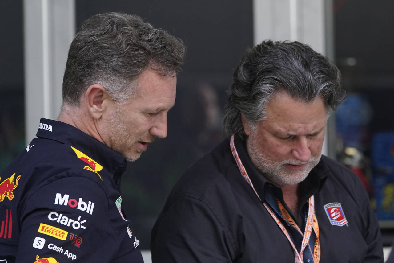 Red Bull Racing team principal Christian Horner, left, talks with Michael Andretti after the qualif...