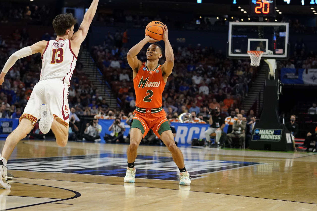 FILE - Miami's Isaiah Wong (2) shoots and scores during the first half of a college basketball game...