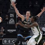 
              Seattle Storm guard Jewell Loyd, center, passes around the defense of Chicago Sky forward Emma Meesseman during the first half of a WNBA basketball game Wednesday, May 18, 2022, in Seattle. (AP Photo/Ted S. Warren)
            