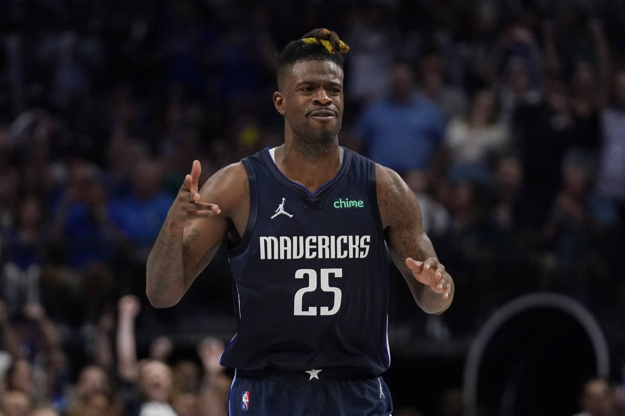 Dallas Mavericks forward Reggie Bullock (25) reacts after scoring against the Phoenix Suns during t...