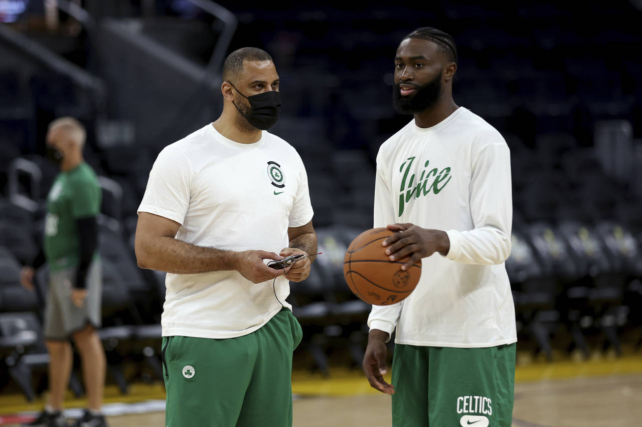 Boston Celtics guard Jaylen Brown, right, speaks with coach Ime Udoka during NBA basketball practic...