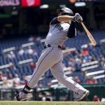 
              Seattle Mariners' Eugenio Suarez hits a three-run home run in the first inning of the first game of a baseball doubleheader against the Washington Nationals, Wednesday, July 13, 2022, in Washington. (AP Photo/Patrick Semansky)
            