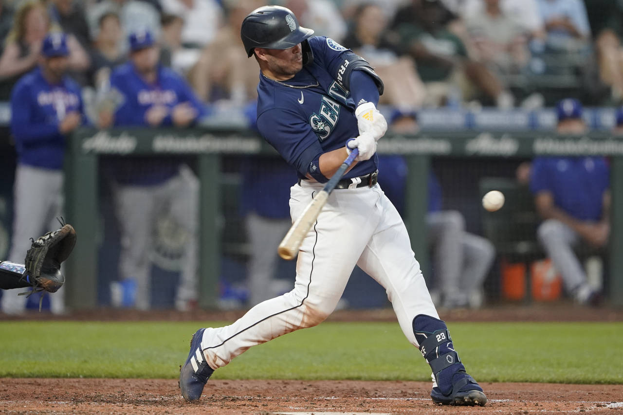 Seattle Mariners' Ty France hits a solo home run against the Texas Rangers during the fifth inning ...
