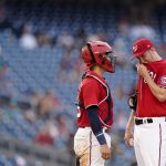 
              Washington Nationals starting pitcher Erick Fedde, right, visits with catcher Tres Barrera in the sixth inning of the second game of a baseball doubleheader against the Seattle Mariners, Wednesday, July 13, 2022, in Washington. Fedde was relieved in the sixth. (AP Photo/Patrick Semansky)
            