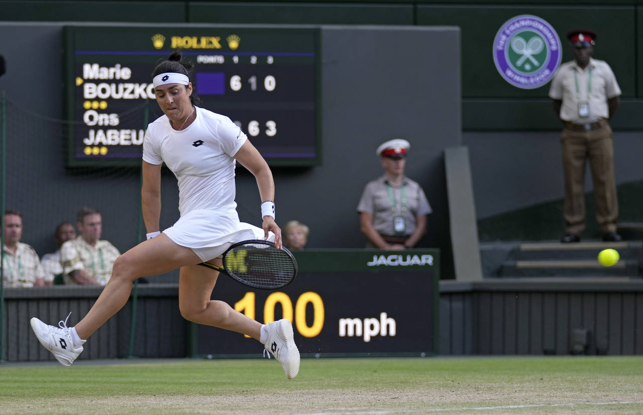 Tunisia's Ons Jabeur returns from between her legs to Marie Bouzkova of the Czech Republic in a wom...