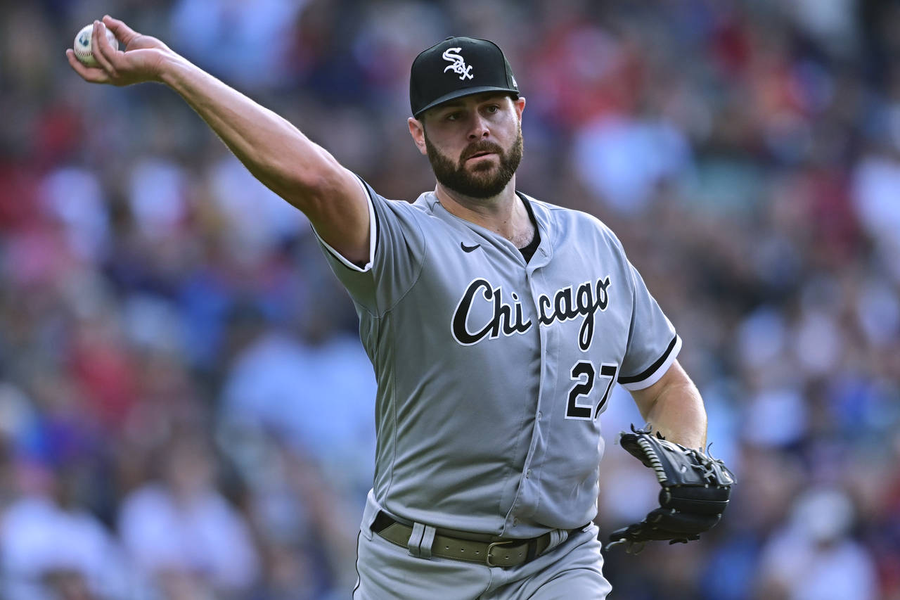Chicago White Sox starting pitcher Lucas Giolito throw to first for the out on Cleveland Guardians'...