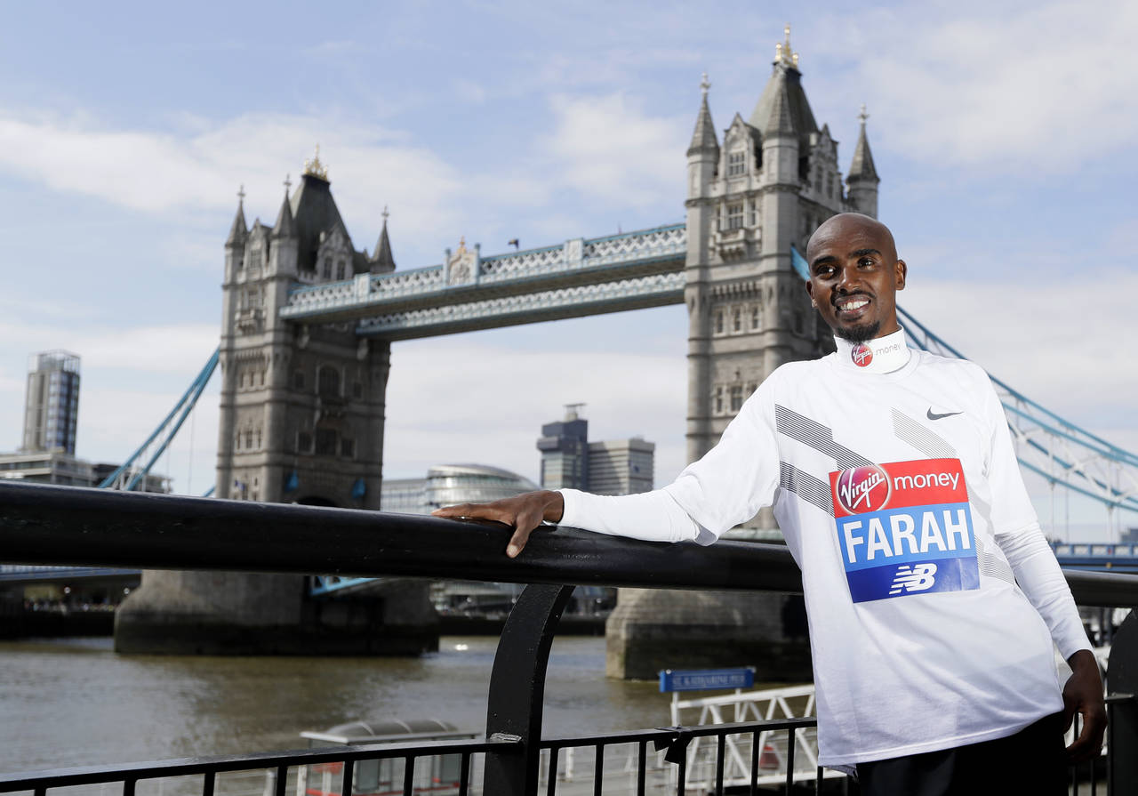 FILE - Britain's Mo Farah poses for the media at a photocall near Tower Bridge in London, Tuesday, ...