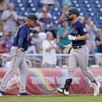 
              Seattle Mariners' Jesse Winker, right, rounds the bases past third base coach Manny Acta after hitting a solo home run in the sixth inning of the second game of a baseball doubleheader against the Washington Nationals, Wednesday, July 13, 2022, in Washington. (AP Photo/Patrick Semansky)
            