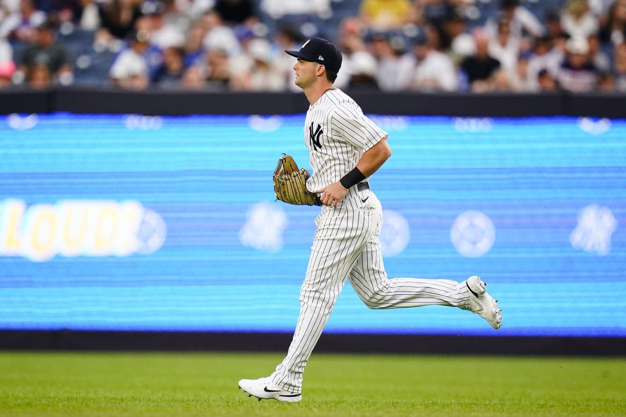 New York Yankees' Andrew Benintendi takes the field for the team's baseball game against his former...