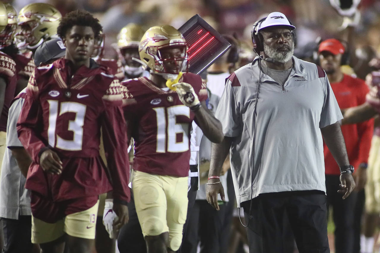 Florida State associate head coach/defensive tackles coach Odell Haggins, right, looks on in the fo...