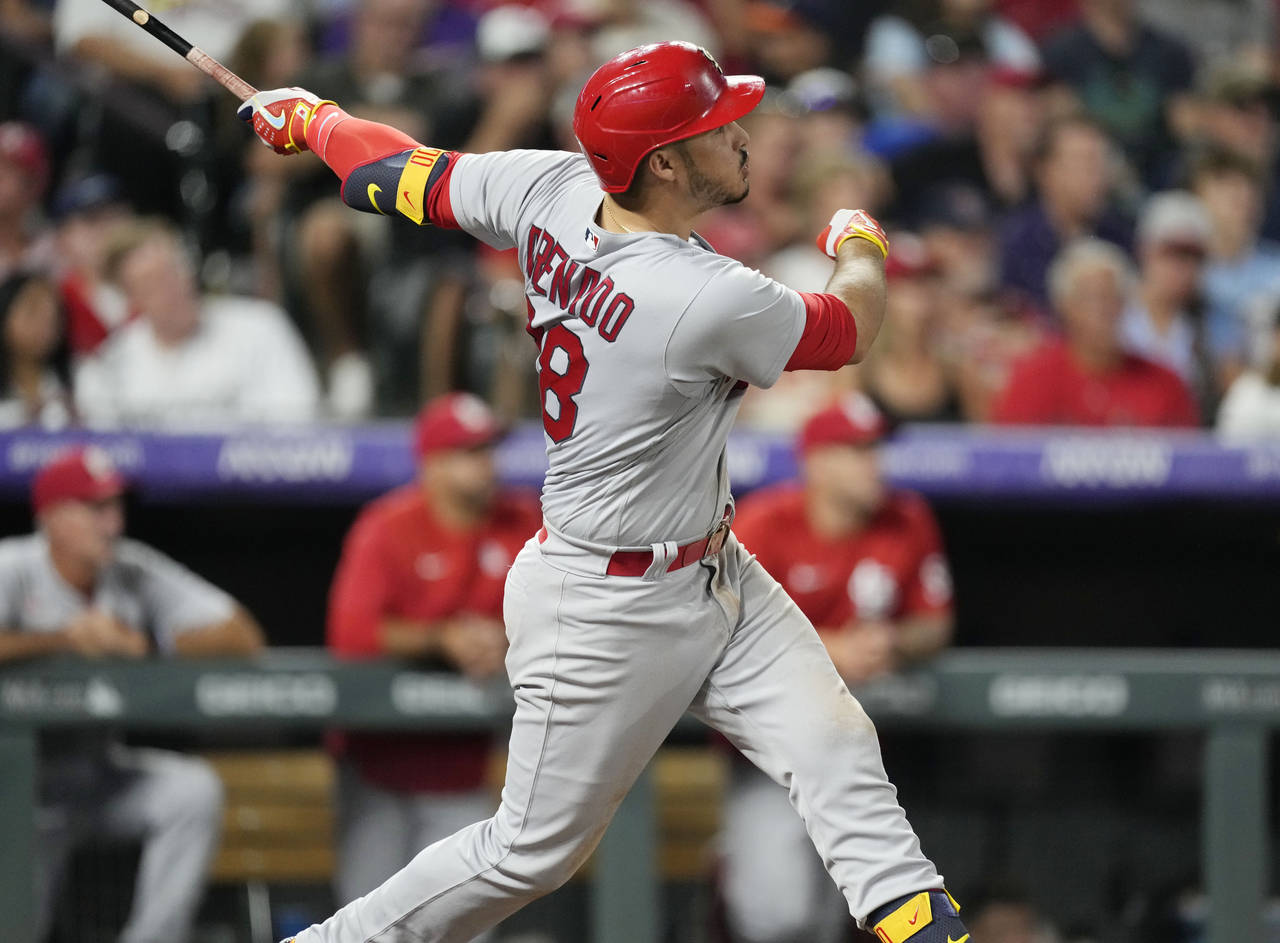 St. Louis Cardinals' Nolan Arenado watches his solo home run off Colorado Rockies relief pitcher Au...