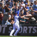 
              Seattle Mariners first baseman Ty France makes a catch at the netting of a foul ball hit by Los Angeles Angels' Kurt Suzuki during the ninth inning of a baseball game Saturday, Aug. 6, 2022, in Seattle. (AP Photo/Caean Couto)
            
