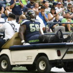 
              Seattle Seahawks guard Damien Lewis (68) is taken off the field on a cart after an injury during the first half of a preseason NFL football game against the Chicago Bears, Thursday, Aug. 18, 2022, in Seattle. (AP Photo/Caean Couto)
            