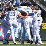 
              Seattle Mariners players celebrate with a group dance in center field after defeating the Los Angeles Angels in the first game of a baseball doubleheader, Saturday, Aug. 6, 2022, in Seattle. (AP Photo/Caean Couto)
            