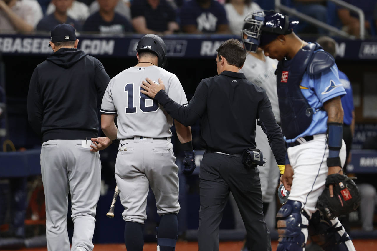 New York Yankees' Andrew Benintendi, who was batting, leaves the team's baseball game against the T...