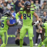 
              Seattle Seahawks tight end Colby Parkinson (84) celebrates with wide receiver Tyler Lockett, left, and wide receiver Penny Hart (19) after Parkinson caught a pass for a touchdown against the Denver Broncos during the first half of an NFL football game, Monday, Sept. 12, 2022, in Seattle. (AP Photo/Stephen Brashear)
            