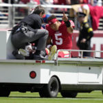 
              San Francisco 49ers quarterback Trey Lance (5) gestures while being carted off the field during the first half of an NFL football game against the Seattle Seahawks in Santa Clara, Calif., Sunday, Sept. 18, 2022. (AP Photo/Tony Avelar)
            