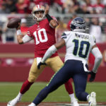 
              San Francisco 49ers quarterback Jimmy Garoppolo, left, passes against Seattle Seahawks linebacker Uchenna Nwosu during the first half of an NFL football game in Santa Clara, Calif., Sunday, Sept. 18, 2022. (AP Photo/Tony Avelar)
            