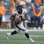 
              Denver Broncos quarterback Russell Wilson drops to pass against the Seattle Seahawks during the first half of an NFL football game, Monday, Sept. 12, 2022, in Seattle. (AP Photo/Stephen Brashear)
            