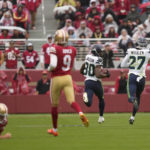 
              Seattle Seahawks' Mike Jackson (30) returns a blocked field goal for a touchdown next to Tariq Woolen (27) past San Francisco 49ers' Mitch Wishnowsky, left, and place kicker Robbie Gould (9) during the second half of an NFL football game in Santa Clara, Calif., Sunday, Sept. 18, 2022. (AP Photo/Tony Avelar)
            