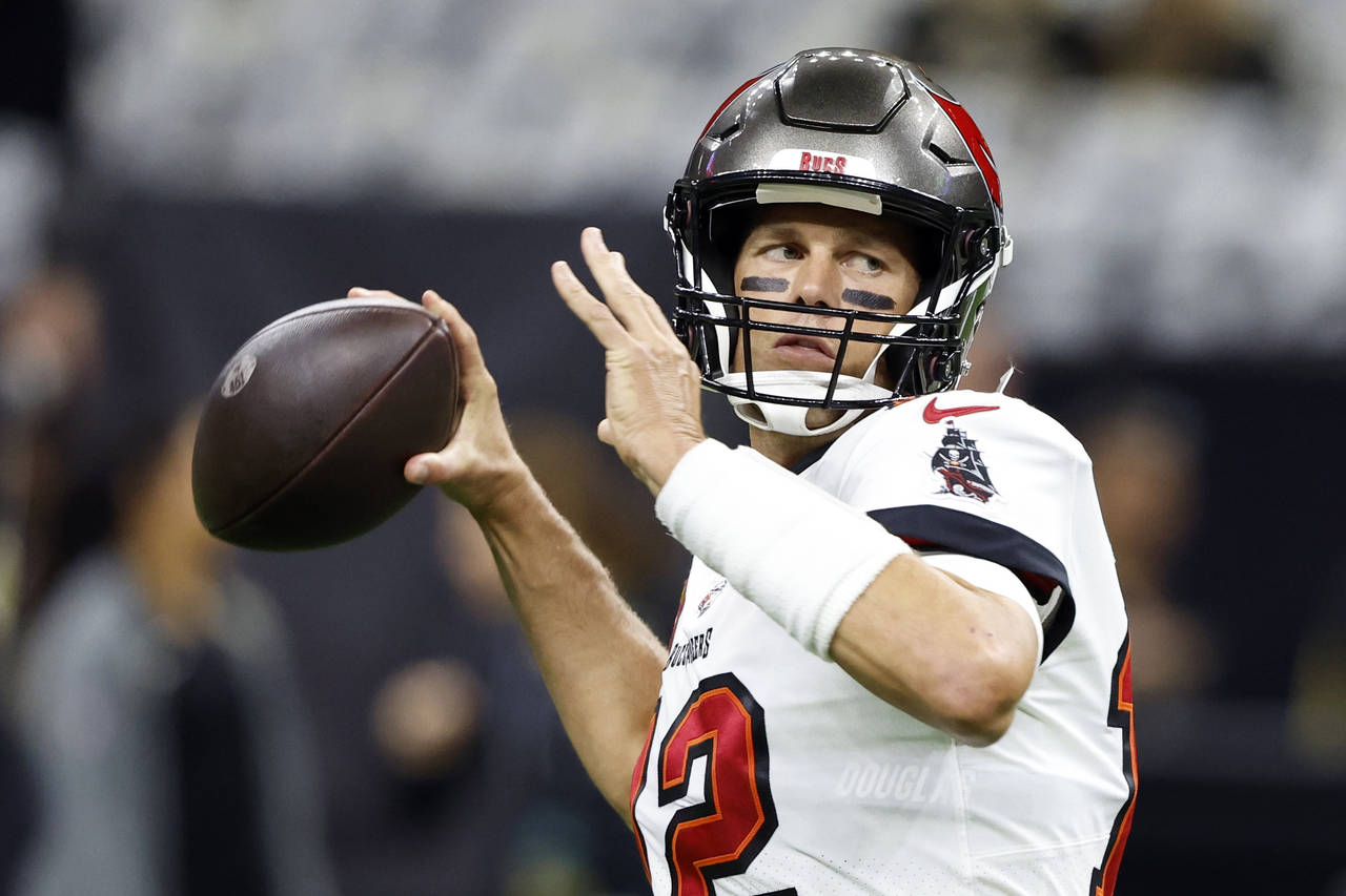 FILE - Tampa Bay Buccaneers quarterback Tom Brady warms up before the first half of an NFL football...