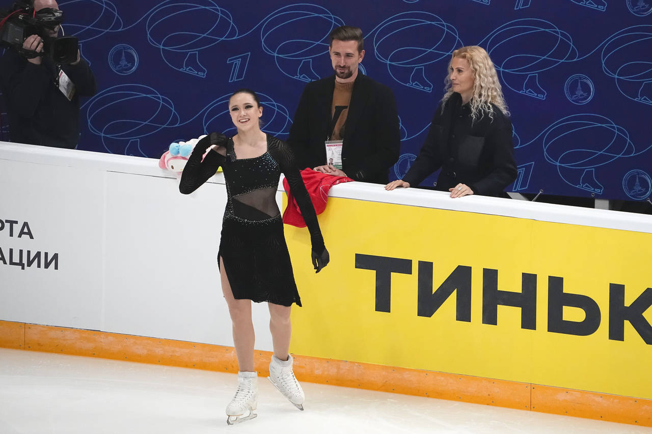 Russian Kamila Valieva, foreground, prepares to compete in the women's free skate program during th...