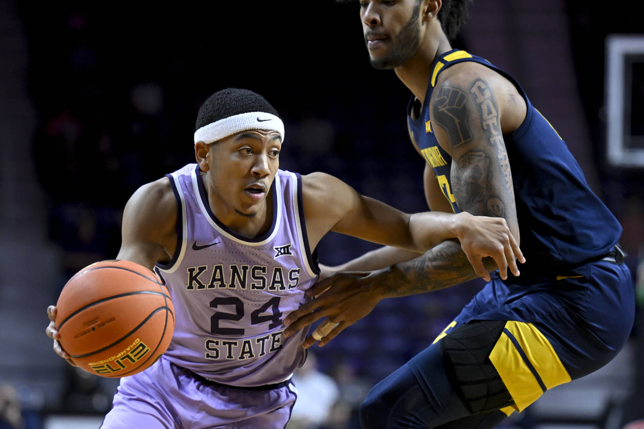 FILE -Kansas State guard Nijel Pack (24) drives around West Virginia forward Isaiah Cottrell (13) d...
