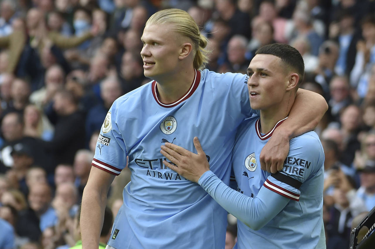 Manchester City's Phil Foden, right, celebrates with his teammate Erling Haaland after scoring his ...