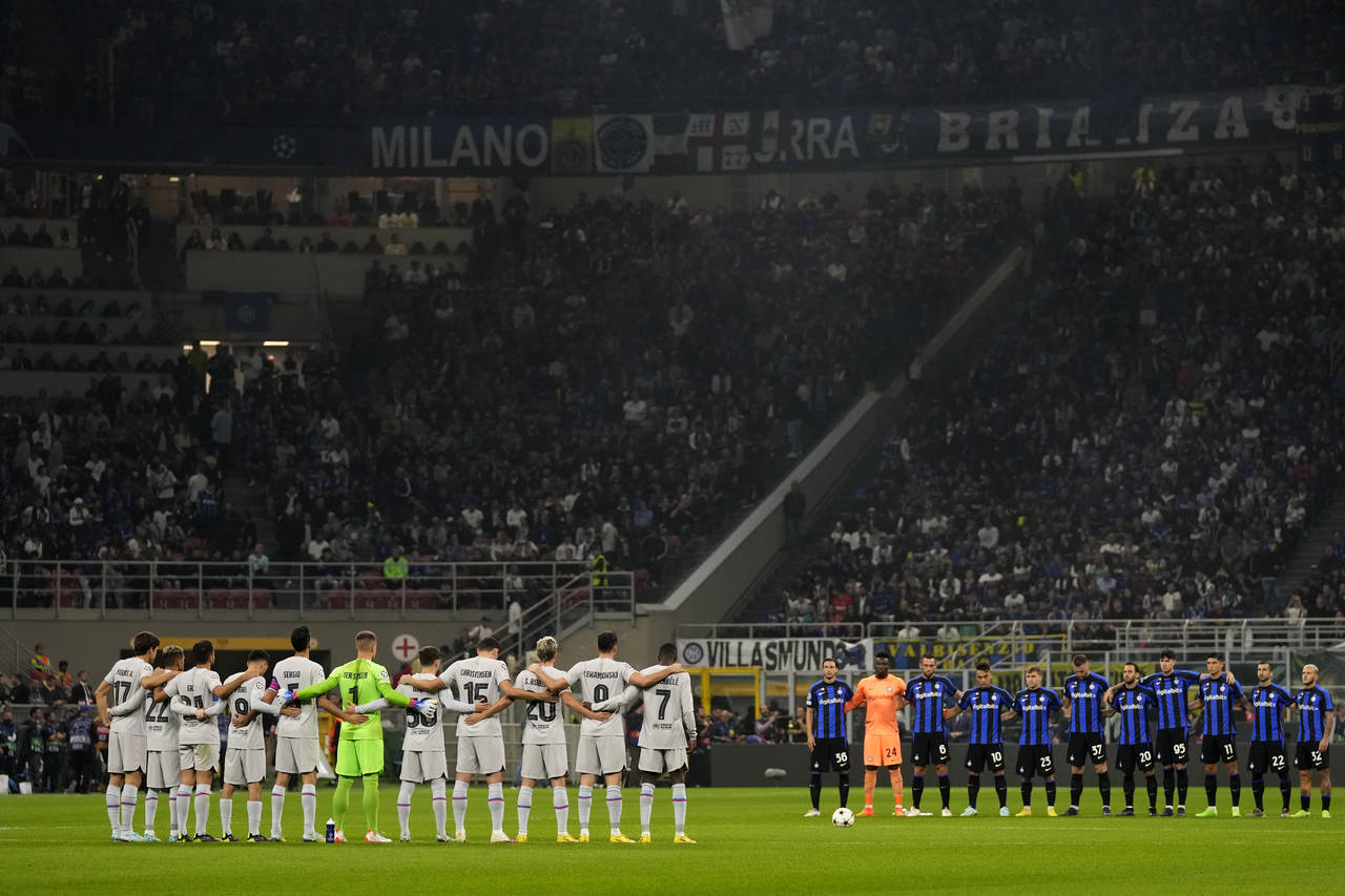 Inter Milan and Barcelona players hold a minute's silence in memory of the victims at Kanjuruhan st...