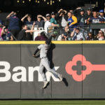 
              Detroit Tigers center fielder Riley Greene can't catch a two-run home run by Seattle Mariners' Mitch Haniger during the third inning of the first game of a baseball doubleheader Tuesday, Oct. 4, 2022, in Seattle. (AP Photo/Caean Couto)
            