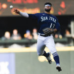 
              Seattle Mariners second baseman Abraham Toro throws to first baseman Ty France for the out on Detroit Tigers' Riley Greene during the fifth inning of the first game of a baseball doubleheader, Tuesday, Oct. 4, 2022, in Seattle. (AP Photo/Caean Couto)
            