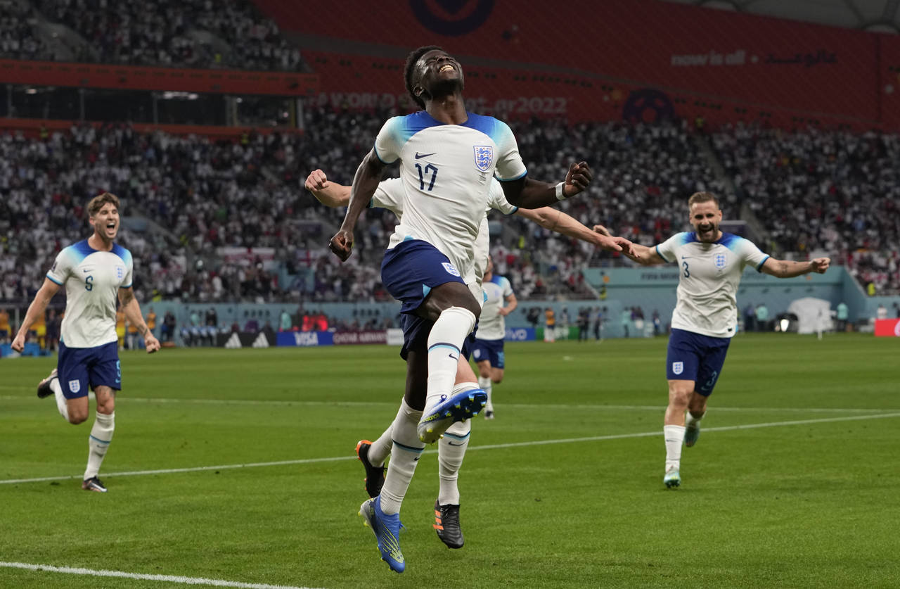 England's Bukayo Saka celebrates after scoring his side's second goal during the World Cup group B ...