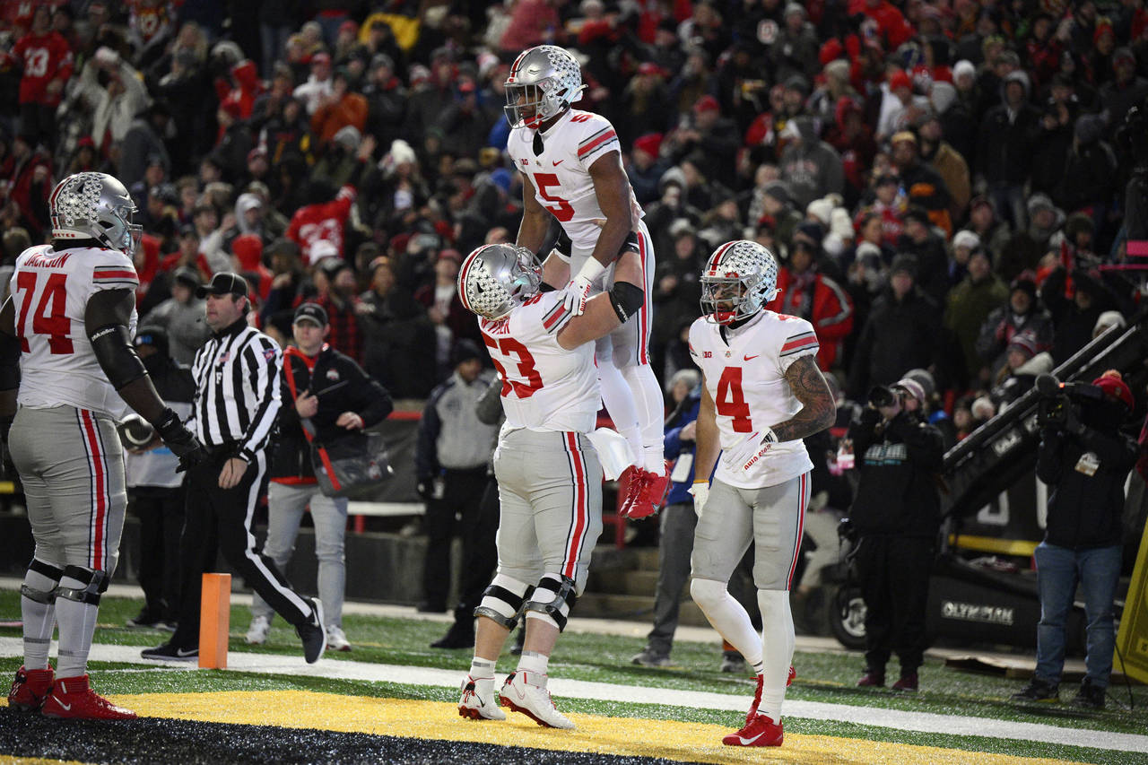 Ohio State running back Dallan Hayden (5) celebrates his touchdown with offensive lineman Luke Wypl...