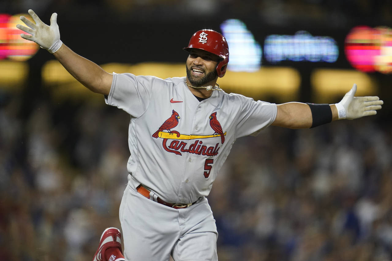 FILE - St. Louis Cardinals designated hitter Albert Pujols (5) reacts after hitting his 700th home ...