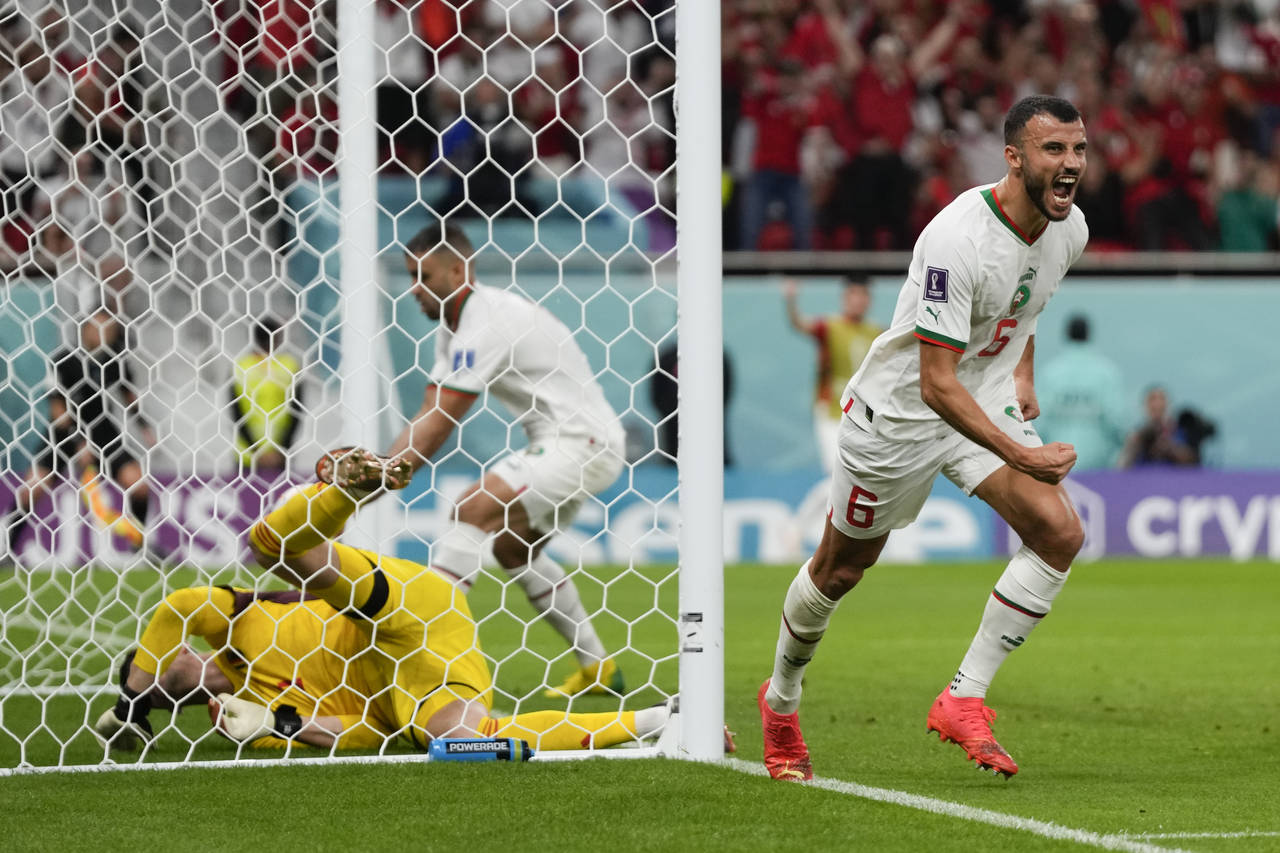 Morocco's Romain Saiss, right, reacts after teammate Abdelhamid Sabiri, not visible, scored a goal ...