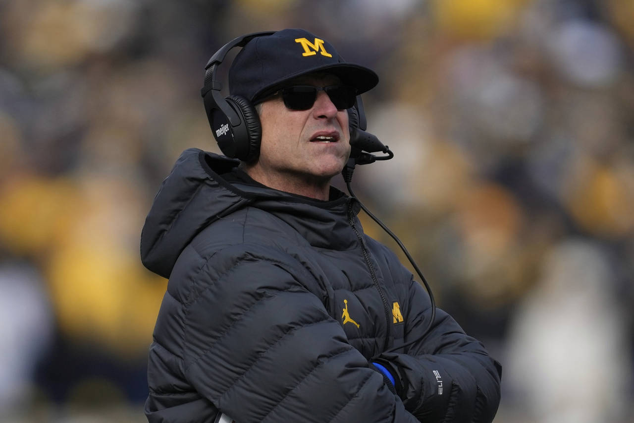 Michigan head coach Jim Harbaugh watches against Illinois in the first half of an NCAA college foot...