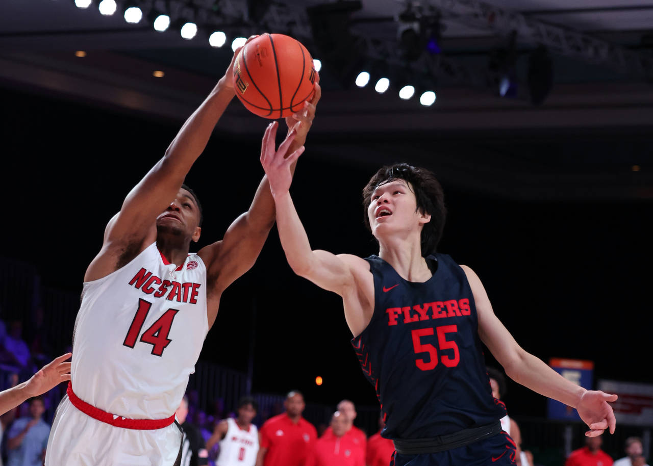 In a photo provided by Bahamas Visual Services, North Carolina State's Casey Morsell (14) grabs the...