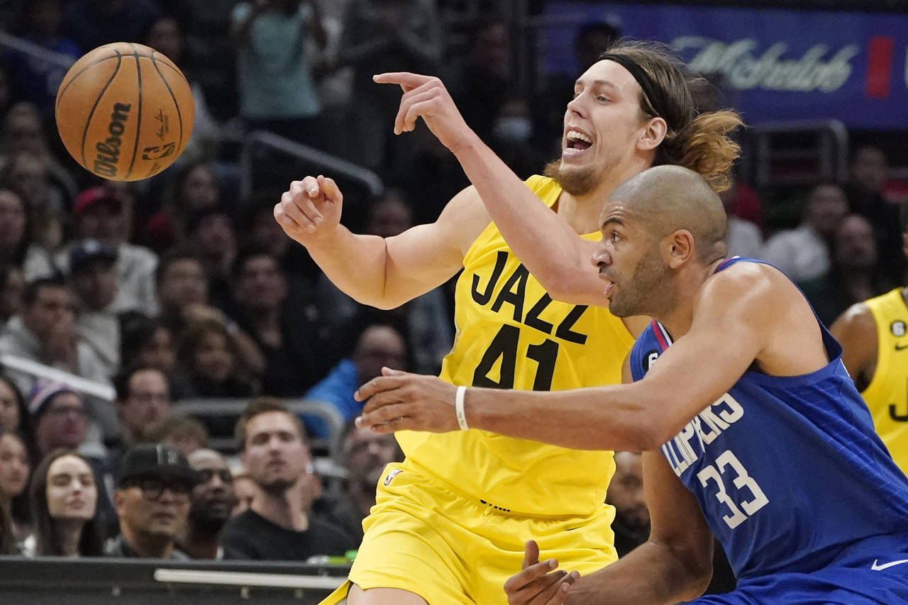 Los Angeles Clippers forward Nicolas Batum, right, steals the ball from Utah Jazz forward Kelly Oly...